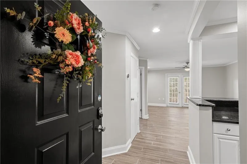 Entryway featuring ornamental molding, wood finish floors, recessed lighting, and ceiling fan