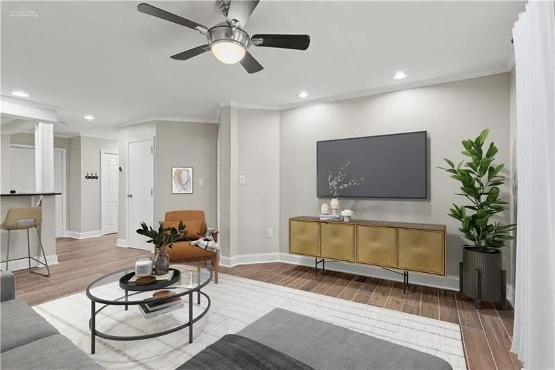 Living area featuring crown molding, recessed lighting, wood finished floors, and a ceiling fan