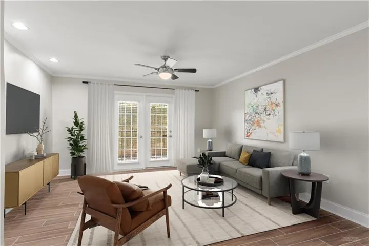 Living area featuring wood finish floors, crown molding, and a ceiling fan