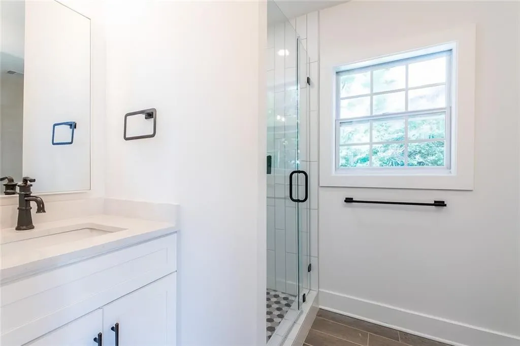 Bathroom with vanity and a shower stall