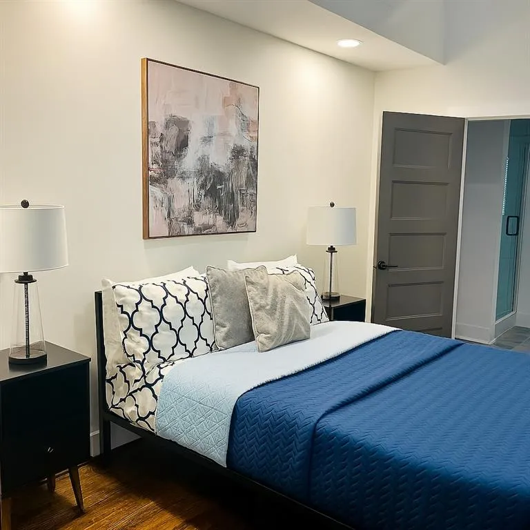 Bedroom with wood finished floors and recessed lighting