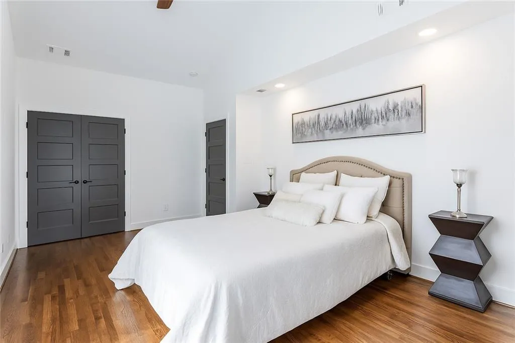 Bedroom with wood finished floors and recessed lighting
