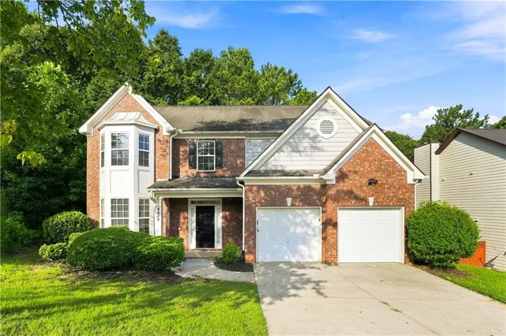 Brick and siding exterior featuring a prominent bay window with white trim