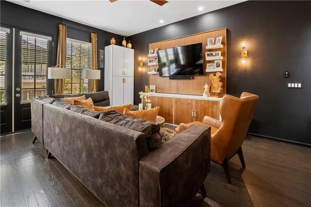 Built-in walnut and white entertainment center with built-in white storage cabinet