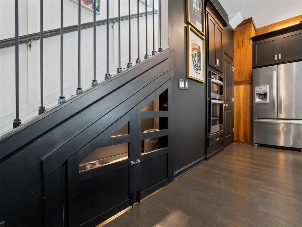 Built in pet room with carriage door entry, high end marble modern tile and mid century lighting