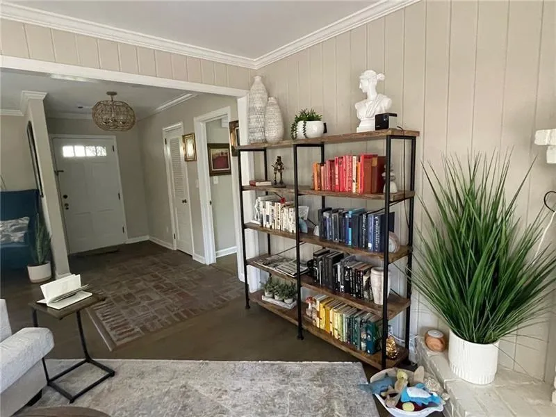 Entrance foyer featuring ornamental molding and a chandelier