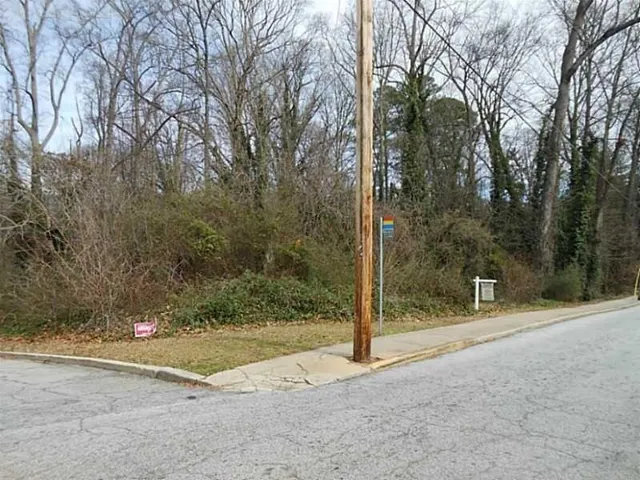 View of asphalt street with curbs and sidewalks