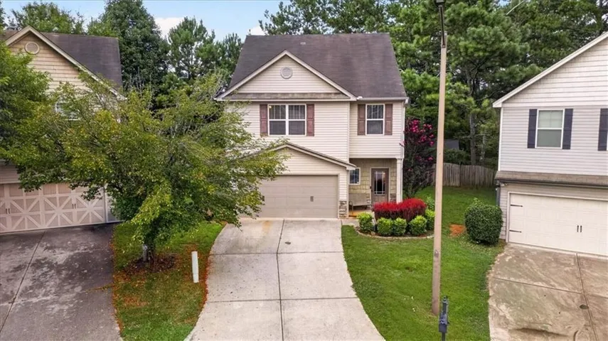 Two-story residence with a front entry garage and a concrete driveway