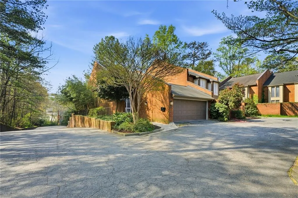 Mid-century inspired home with asphalt driveway and stucco siding