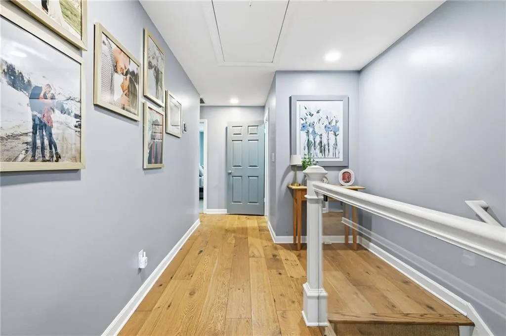 Hall featuring light wood finished floors and recessed lighting
