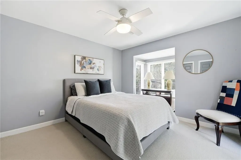 Bedroom featuring light carpet and a ceiling fan