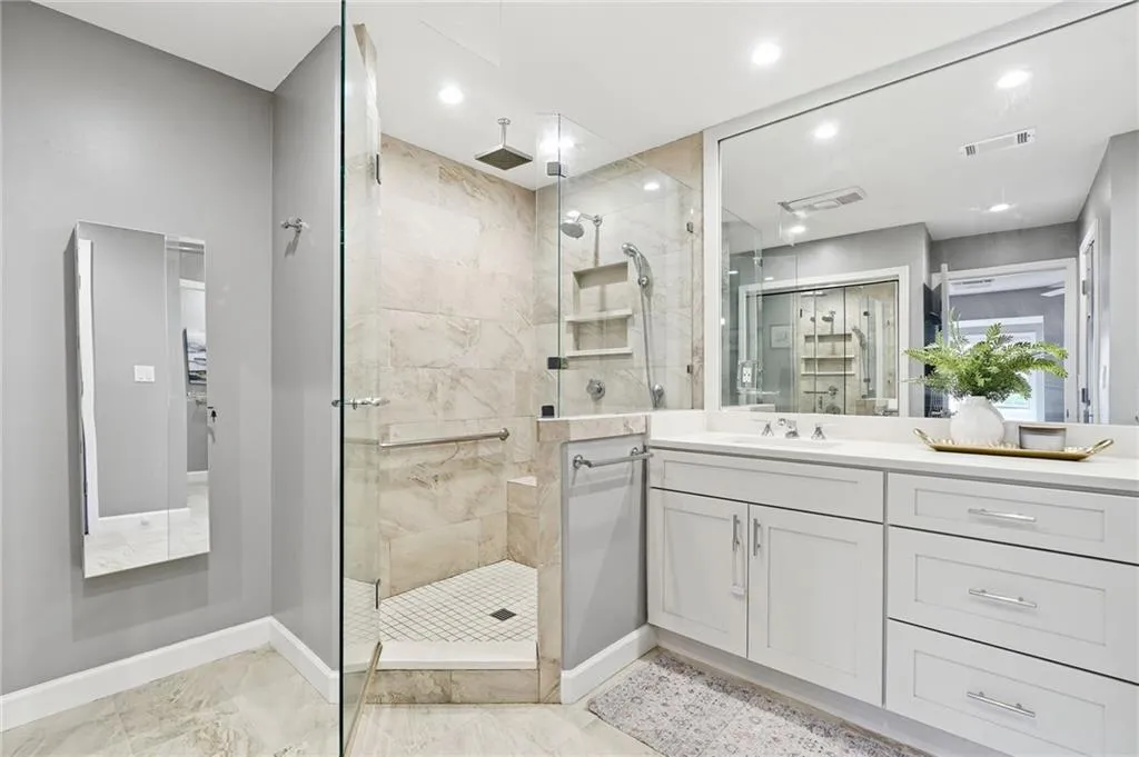 Full bath with vanity, a shower stall, recessed lighting, and light marble finish flooring