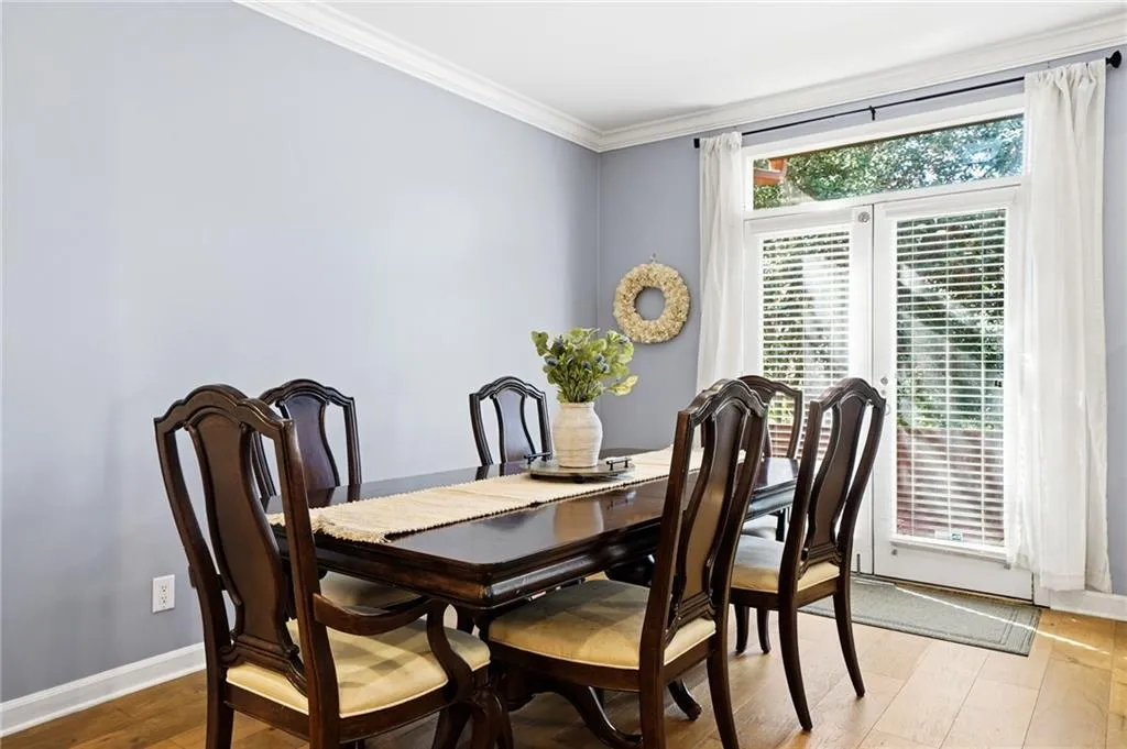 Dining space featuring light wood-style flooring and ornamental molding