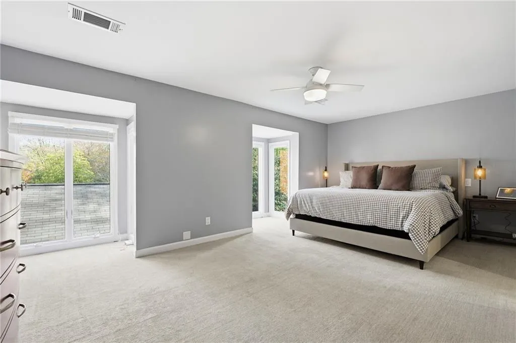 Bedroom featuring light carpet and a ceiling fan