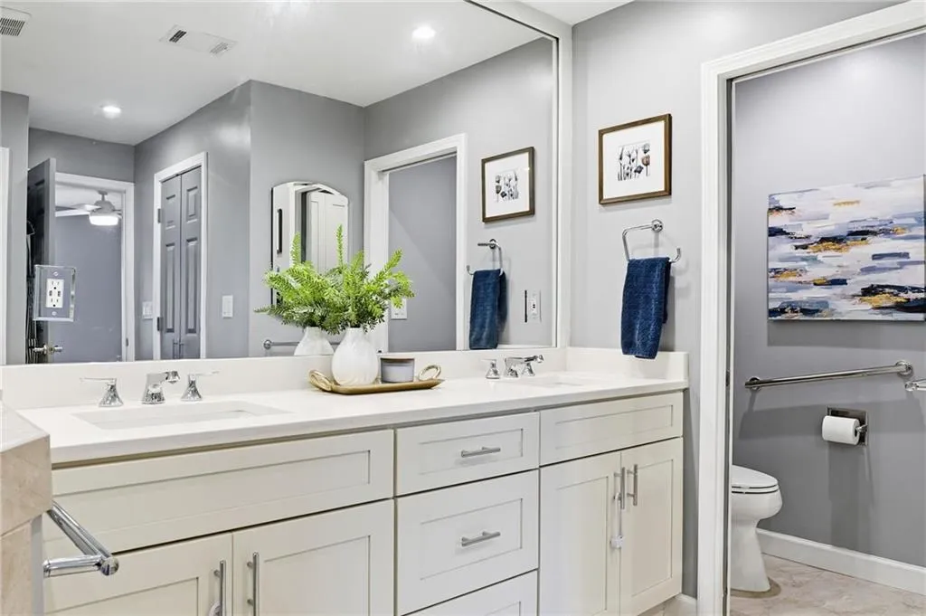 Bathroom featuring double vanity and toilet