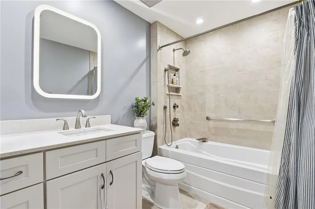 Full bathroom with vanity, shower / bath combination with curtain, recessed lighting, and light tile patterned floors