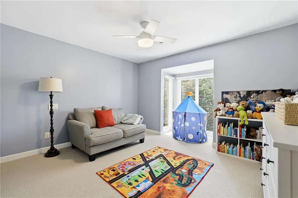 Recreation room featuring light carpet and ceiling fan