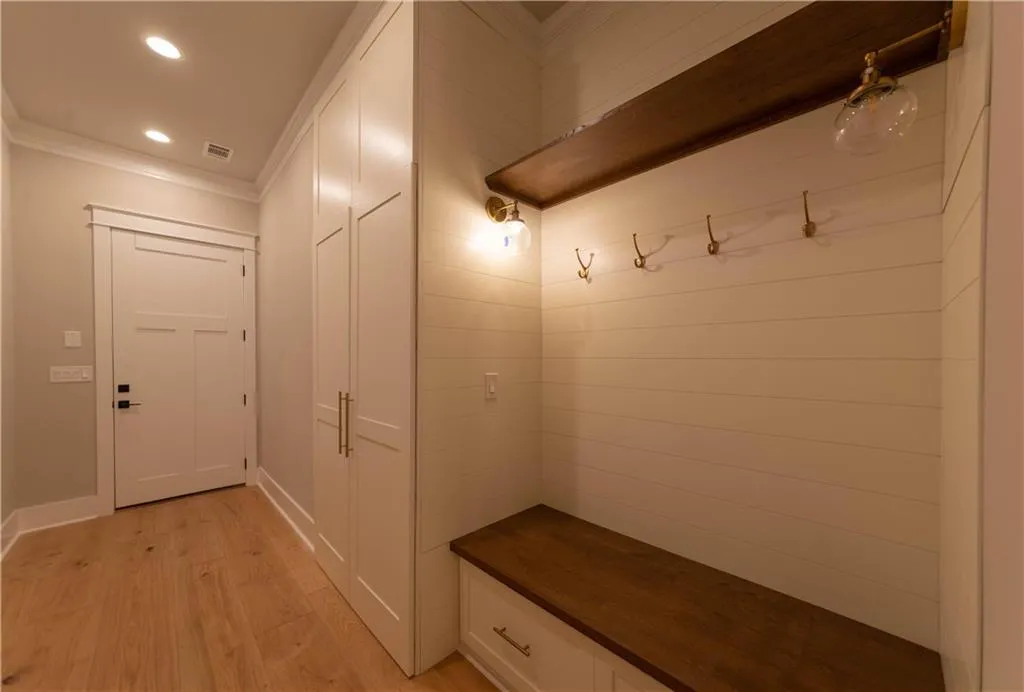 Mudroom featuring light hardwood / wood-style flooring and crown molding