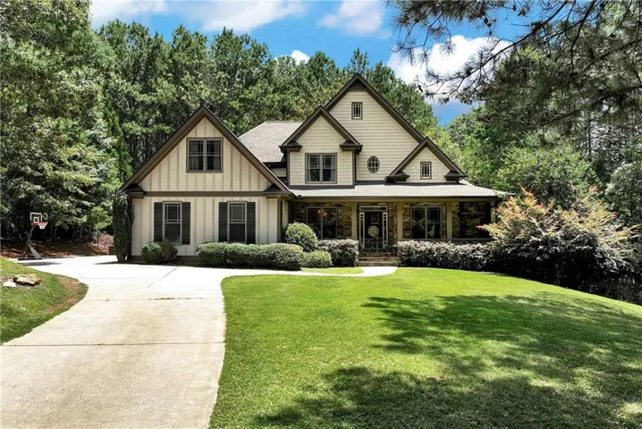 Gabled roofline architectural style with a covered front porch and stone accents