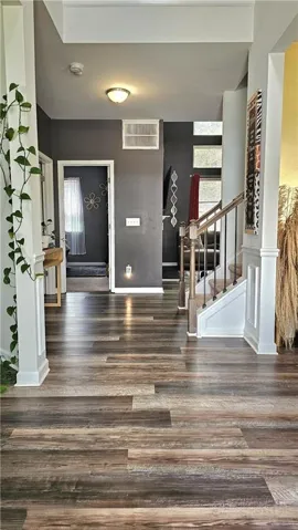 Luxury Vinyl Flooring, staircase with dark handrail, overhead light fixture