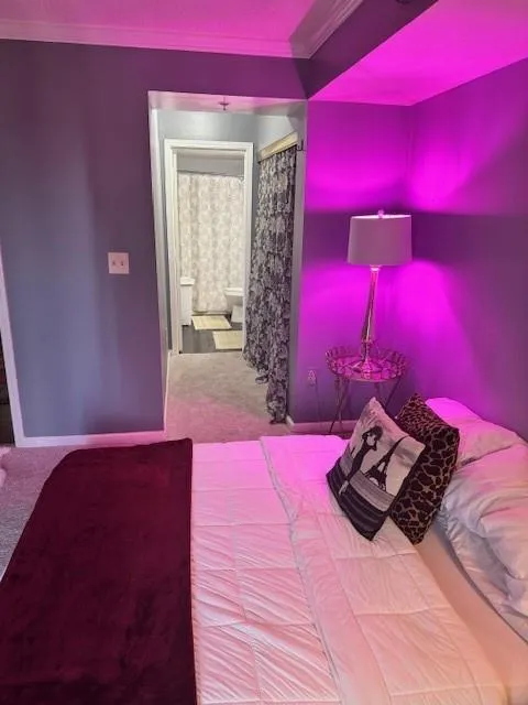 Unfurnished bedroom featuring carpet flooring and crown molding