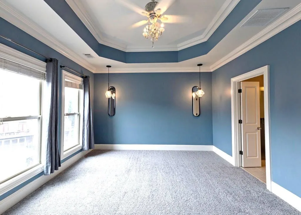 Master Bedroom With New Carpets, Ceiling Fan, Tray-Ceiling, Crown Molding, And Sunny Double Pane Windows