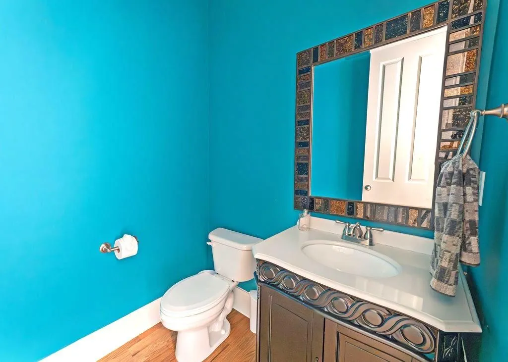 Half Bathroom On Main Level With Hardwood Floors.