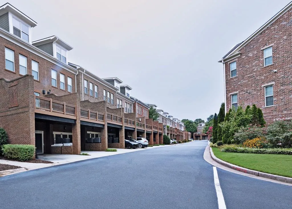 Safe, Gated Community. Each Townhouse has a 2 Car Garage with additional Under Deck Parking for 2 More Vehicles. Additional 'Visitor' Parking Spaces are scattered around the community.