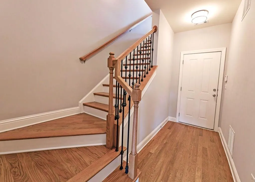 Staircase with Hardwood Floors To Terrace/Garage level.