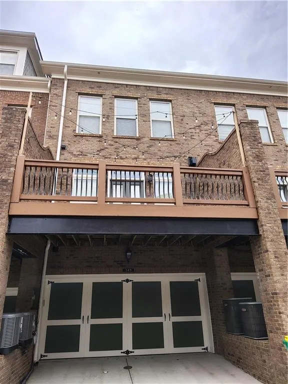 Rear View Of Home With 2 Car Garage & Large Back Deck.