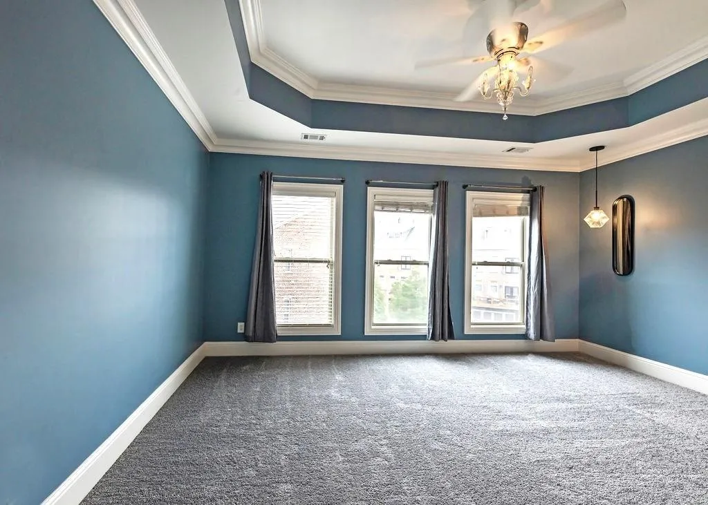 Master Bedroom With New Carpets, Ceiling Fan, Tray-Ceiling, Crown Molding, And Sunny Double Pane Windows