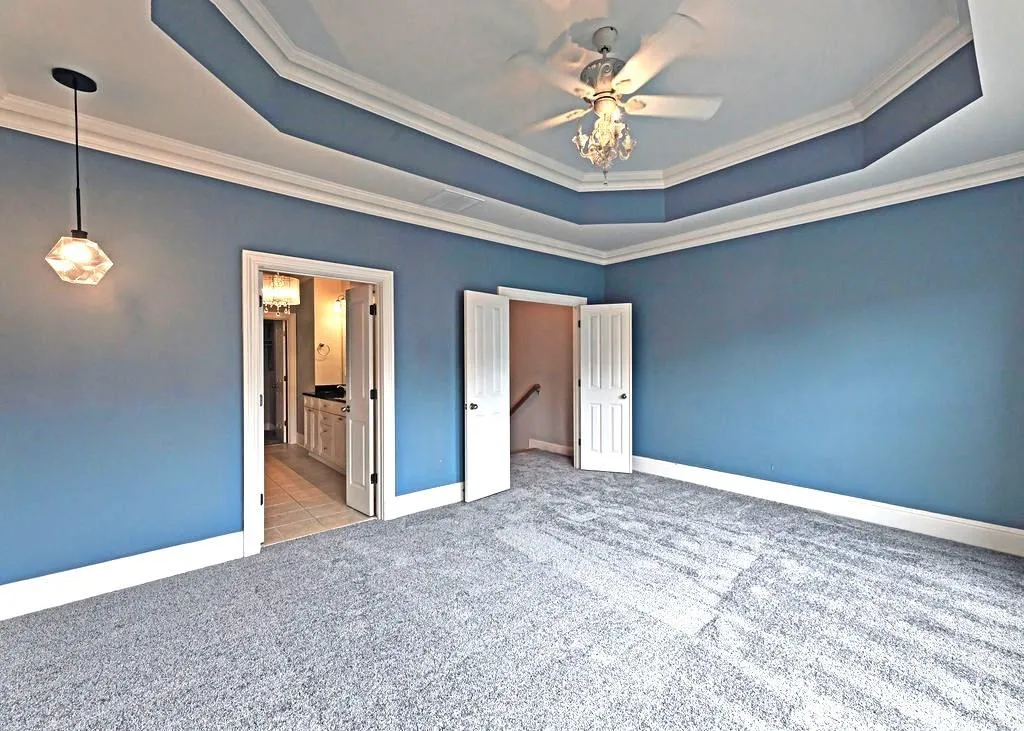 Master Bedroom With New Carpets, Ceiling Fan, Tray-Ceiling, Crown Molding, And Sunny Double Pane Windows