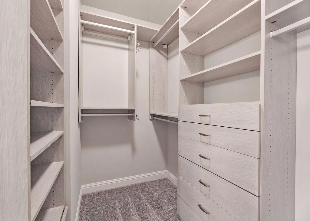 Spacious Closet With Built-In California Type Shelving And New Carpet.