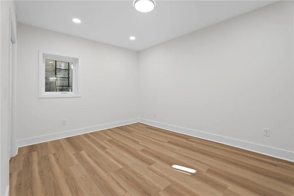 Recessed lighting and a flush-mount ceiling fixture illuminate the space