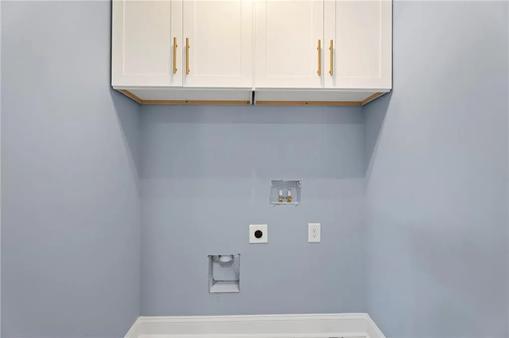 White shaker-style cabinetry with gold-tone hardware