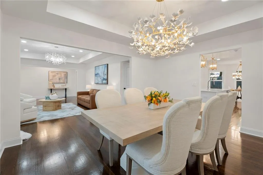 Hardwood flooring, recessed lighting, and a decorative chandelier