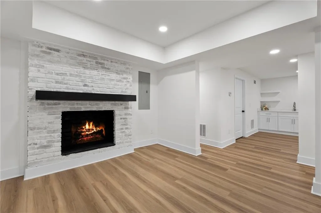 White-painted brick fireplace with a dark wood mantel