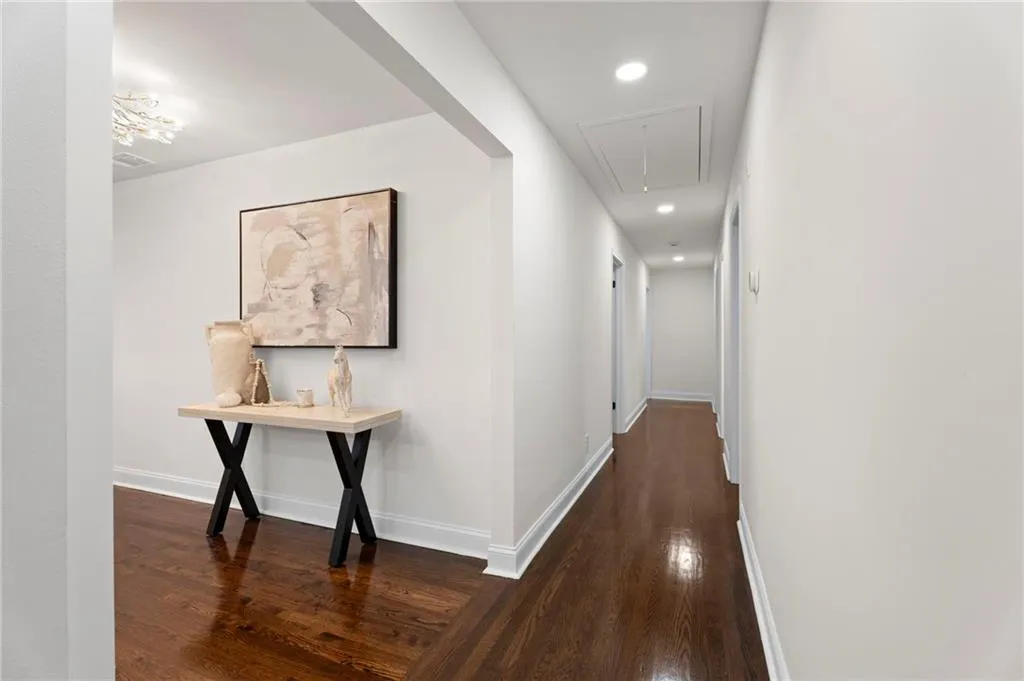 Hardwood flooring, recessed lighting, and white walls