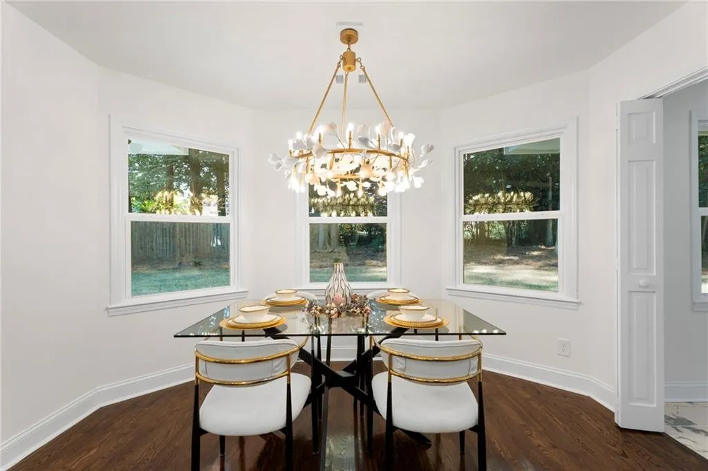 Hardwood flooring, multiple windows, recessed ceiling, and a decorative light fixture
