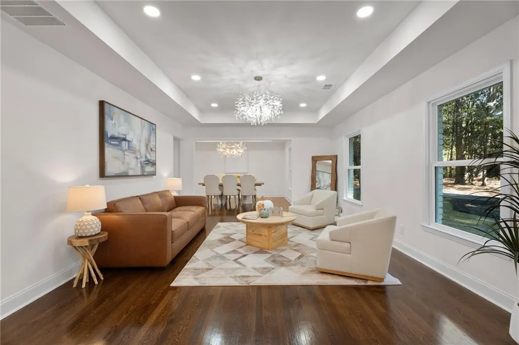 Hardwood flooring, recessed lighting, and a tray ceiling