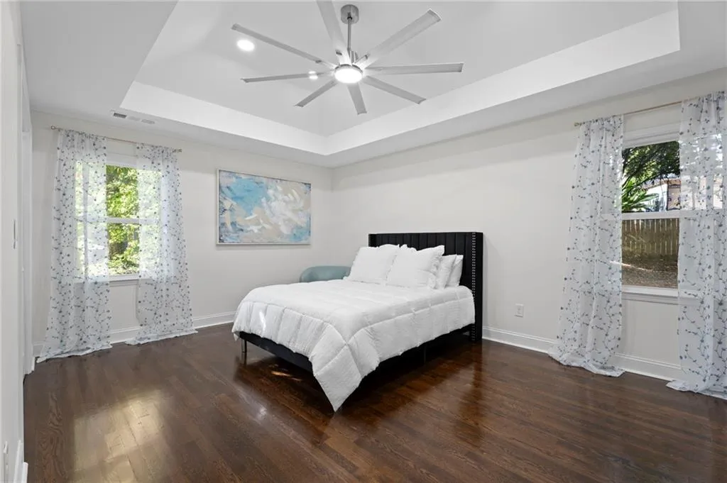 Tray ceiling with recessed lighting and a modern ceiling fan