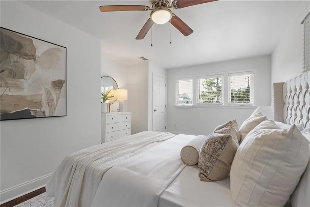 Bedroom featuring a ceiling fan and wood finished floors Bedroom featuring a ceiling fan and wood finished floors