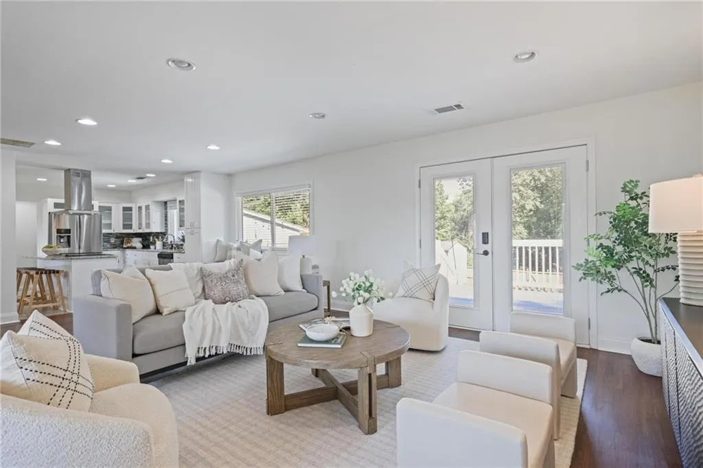 Living area featuring recessed lighting, wood finished floors, and french doors Living area featuring recessed lighting, wood finished floors, and french doors
