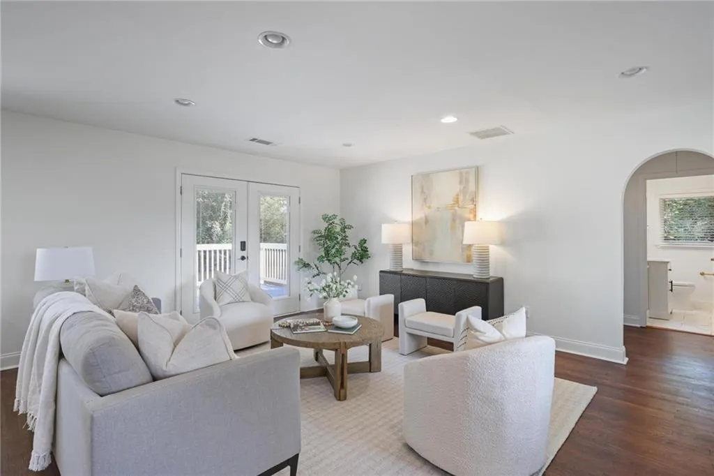Living area featuring arched walkways, wood finished floors, healthy amount of natural light, french doors, and recessed lighting Living area featuring arched walkways, wood finished floors, healthy amount of natural light, french doors, and recessed lighting