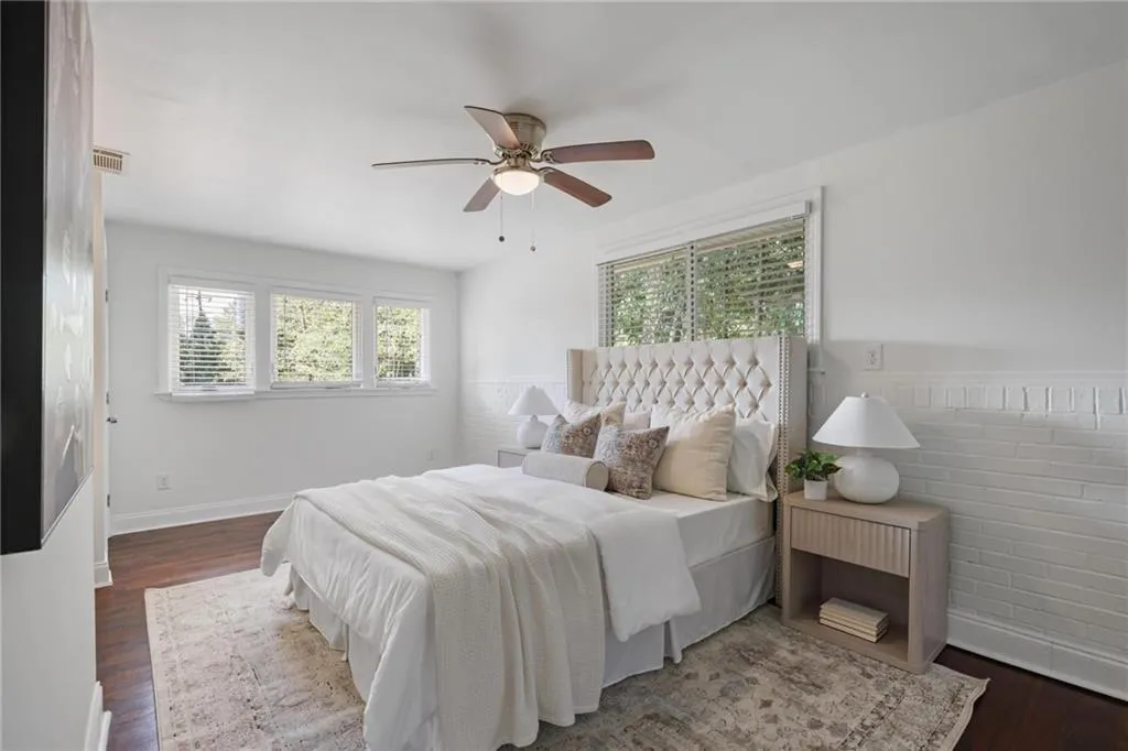 Bedroom featuring dark wood-type flooring and a ceiling fan Bedroom featuring dark wood-type flooring and a ceiling fan