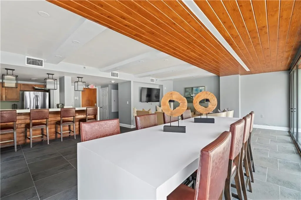 Dining room featuring baseboards and a wooden ceiling with exposed beams