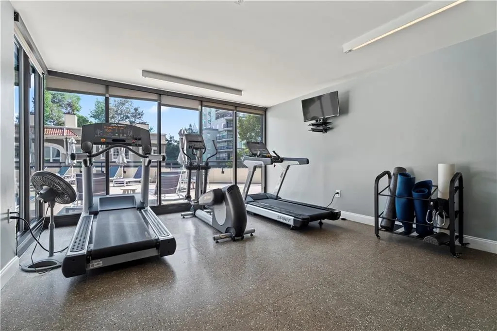 Gym featuring baseboards and expansive windows