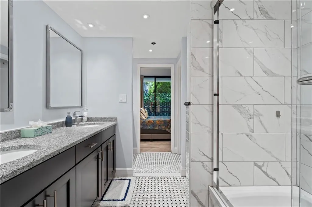 Bathroom with double vanity, ensuite bath, recessed lighting, tile patterned floors, and  shower combination