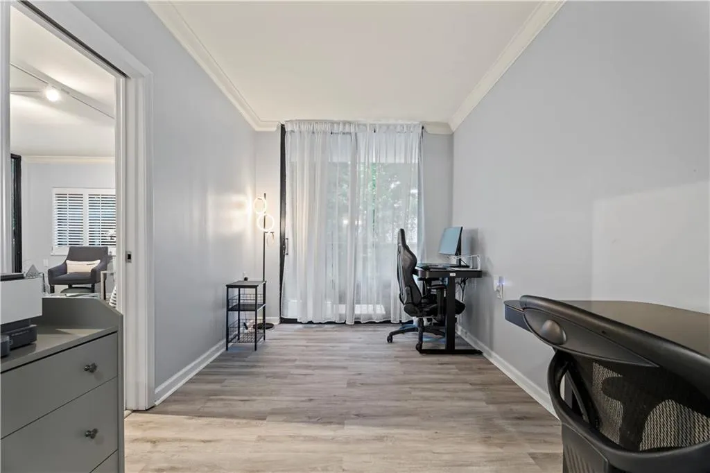 Office featuring light wood finished floors and ornamental molding