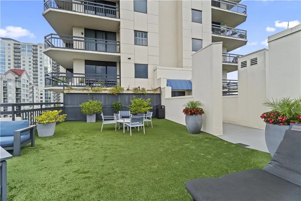 View of property's community with a yard